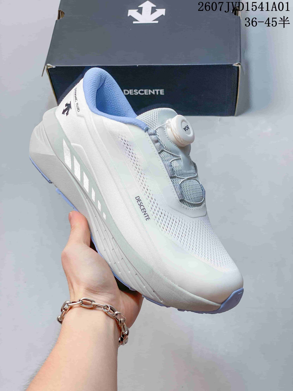 Side view of a white Descente running shoe with light blue accents and dial closure.