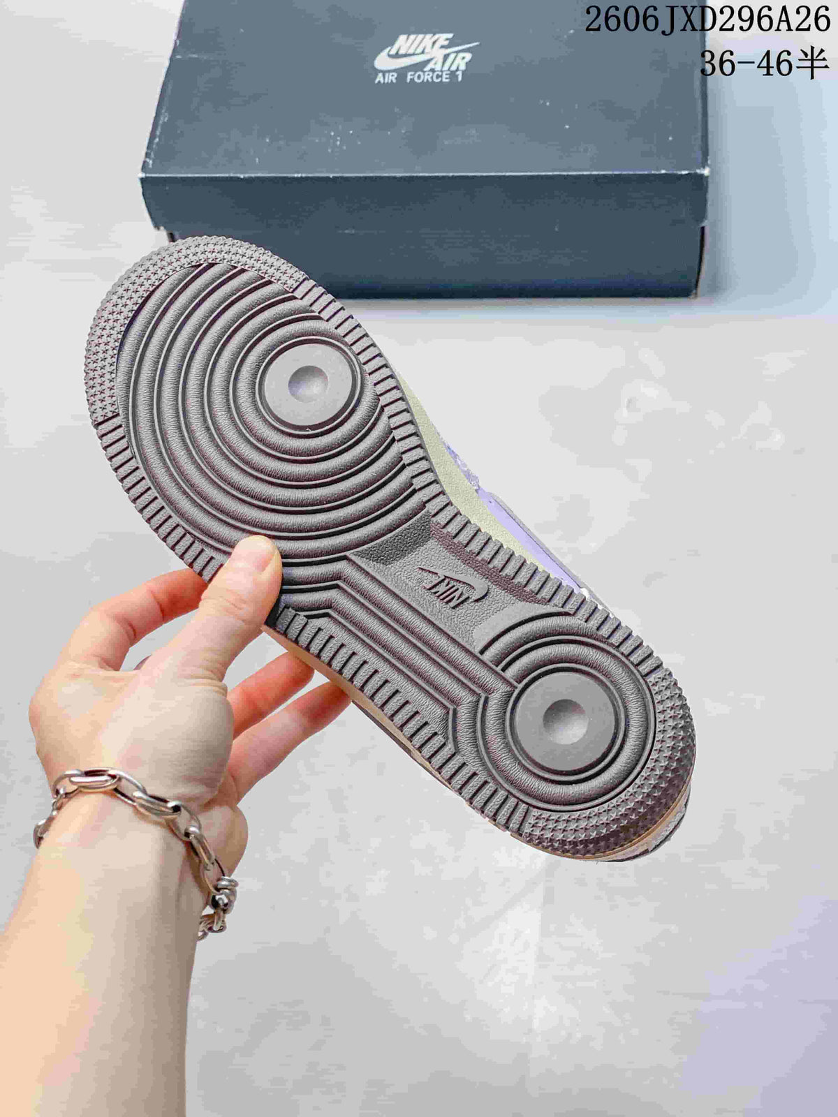 Close-up of the dark grey circular-pattern outsole on a Nike Air Force 1 sneaker