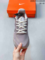Front view of a mauve-gray lace-up sneaker with a padded tongue