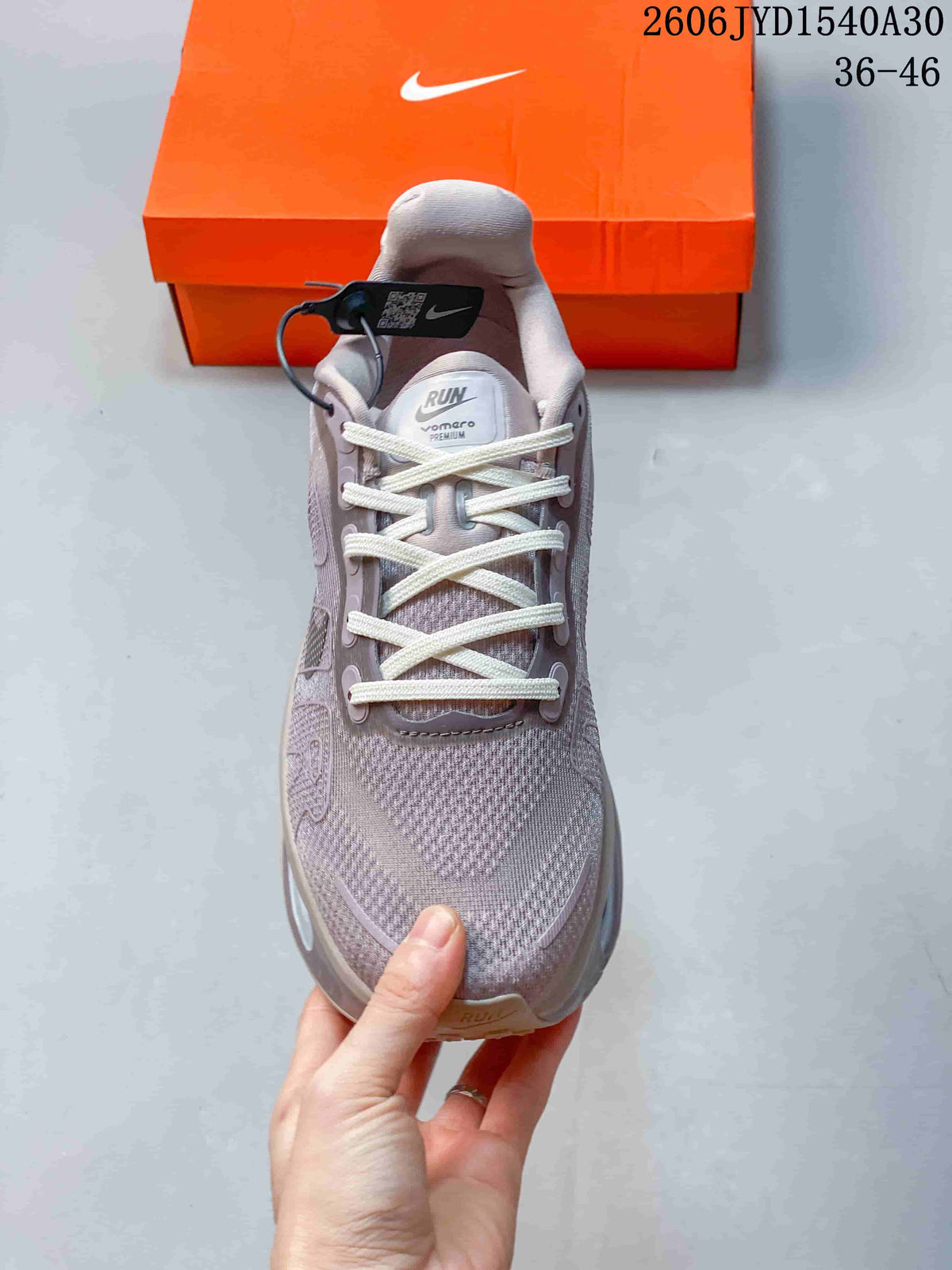 Front view of a mauve-gray lace-up sneaker with a padded tongue