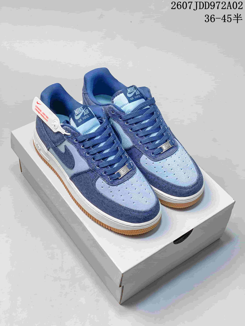 Pair of blue Nike Air Force 1 low-top sneakers with a white midsole and gum outsole