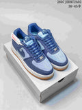 Pair of blue Nike Air Force 1 low-top sneakers with a white midsole and gum outsole