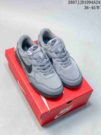 Pair of gray Nike Terra Manta Suede sneakers displayed on a red Nike shoebox.
