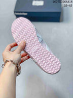 Underside of the pink sneaker showing the repeating textured tread pattern on the rubber outsole.