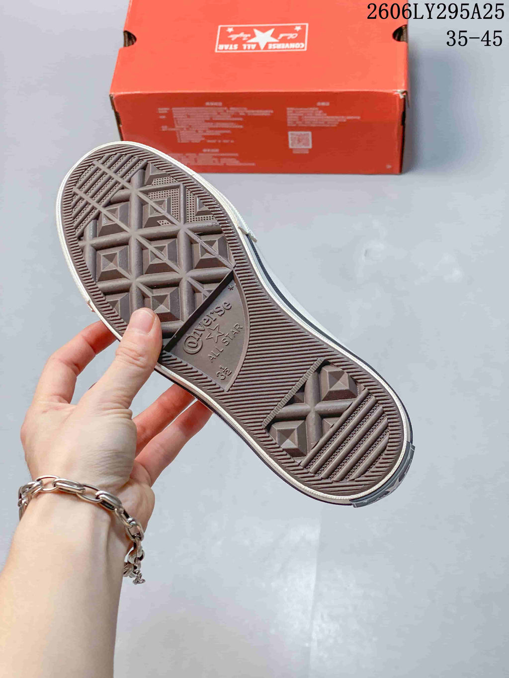 Underside of a Converse sneaker showing the textured geometric rubber tread and All Star branding; the outsole is marked 35.