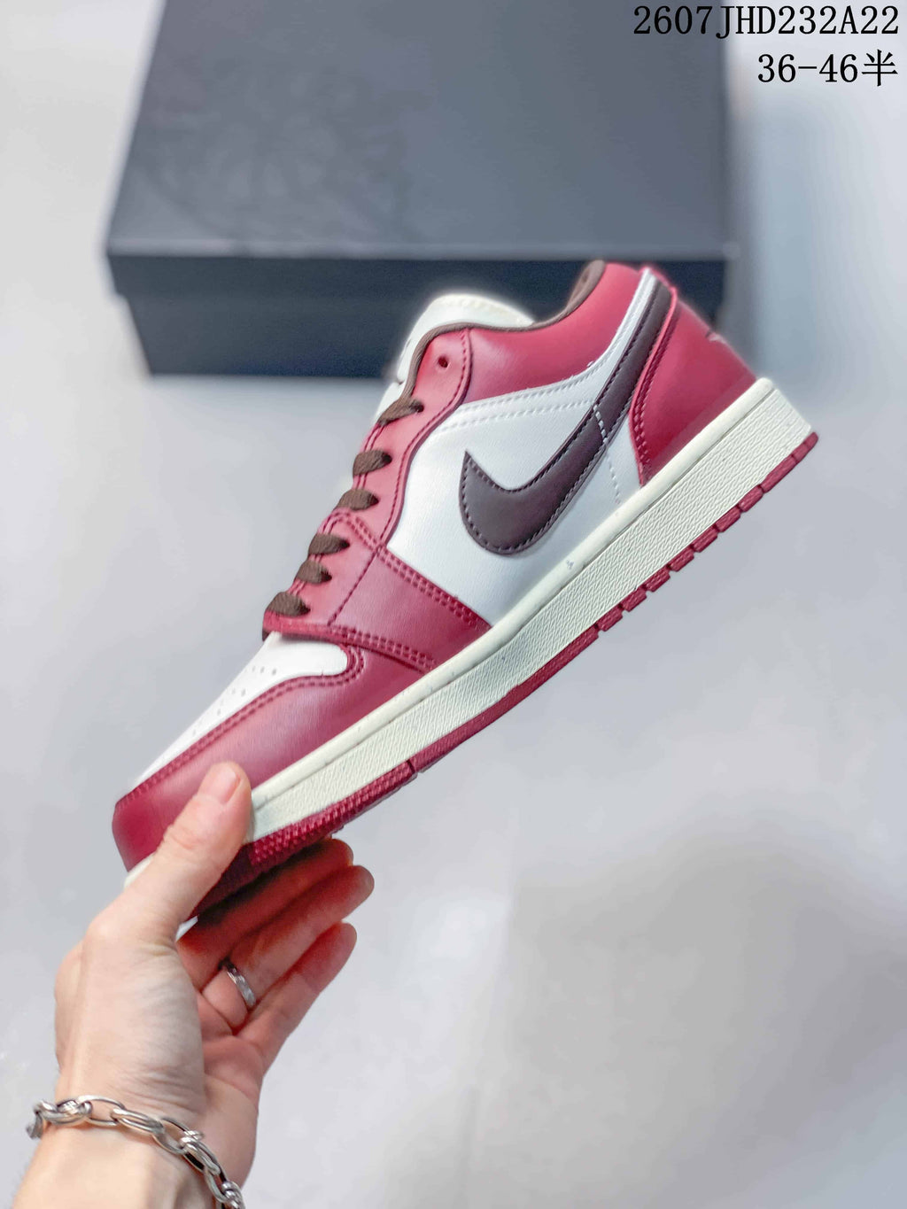 Side profile showing the red and white upper, dark brown Swoosh, white midsole, and red outsole.