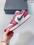 Side profile showing the red and white upper, dark brown Swoosh, white midsole, and red outsole.