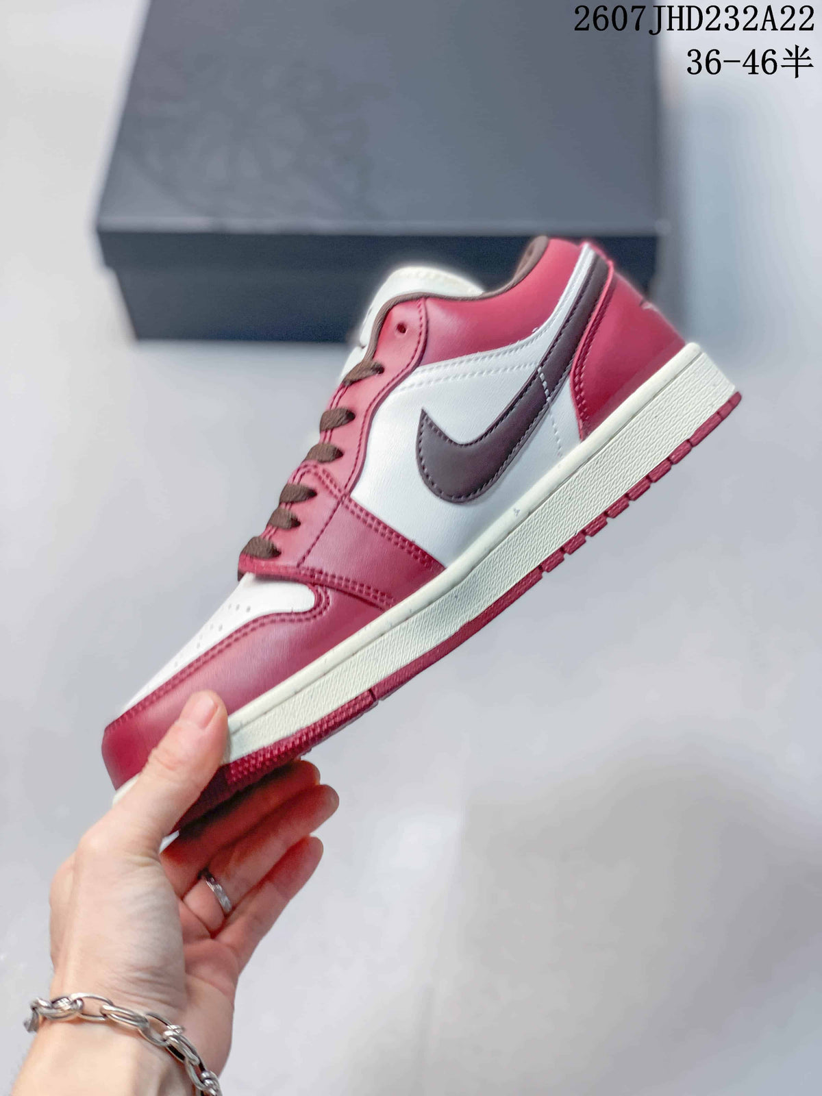 Side profile showing the red and white upper, dark brown Swoosh, white midsole, and red outsole.