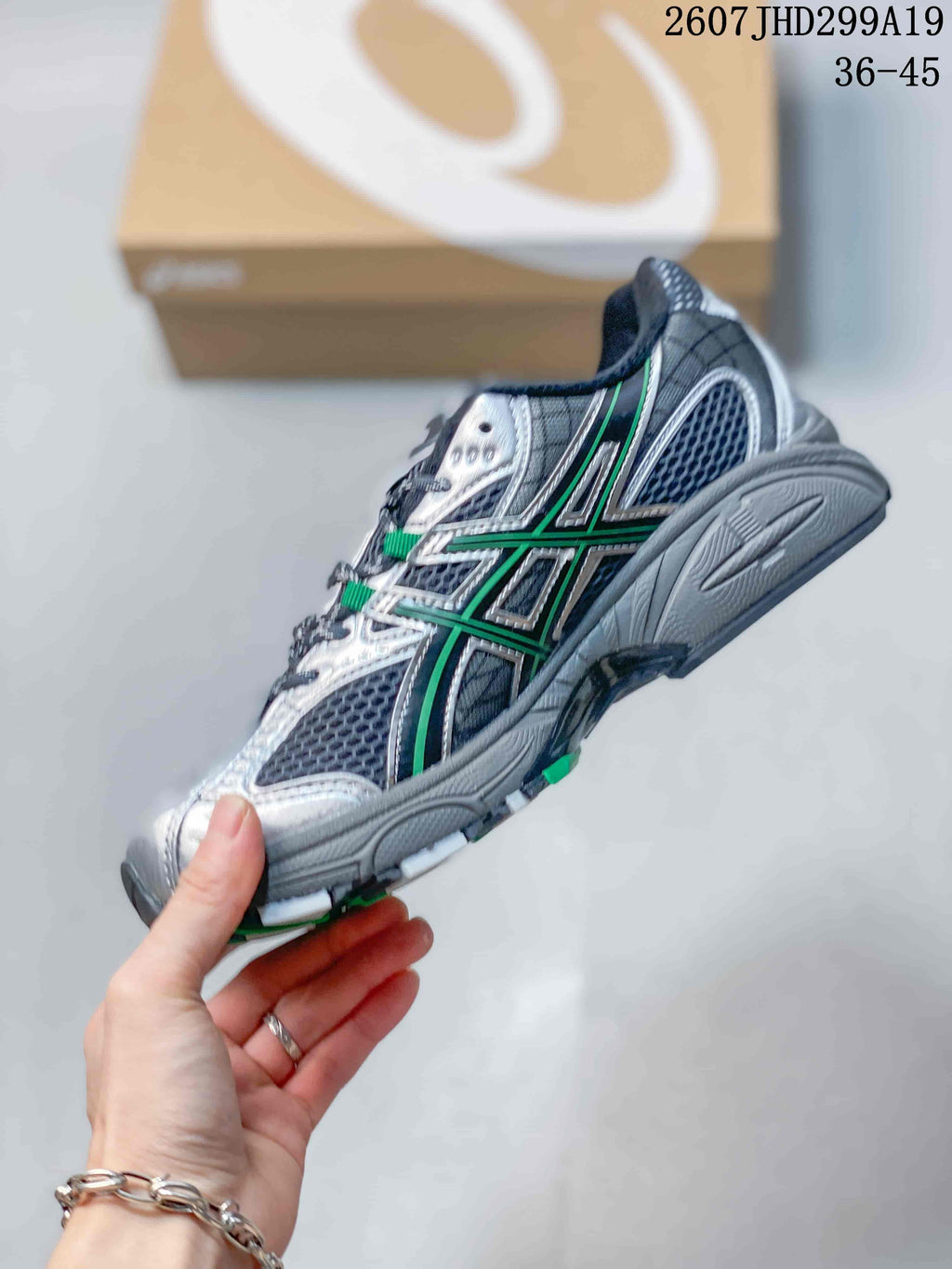 Side view highlighting the silver and green overlays, mesh panels and sculpted sole.