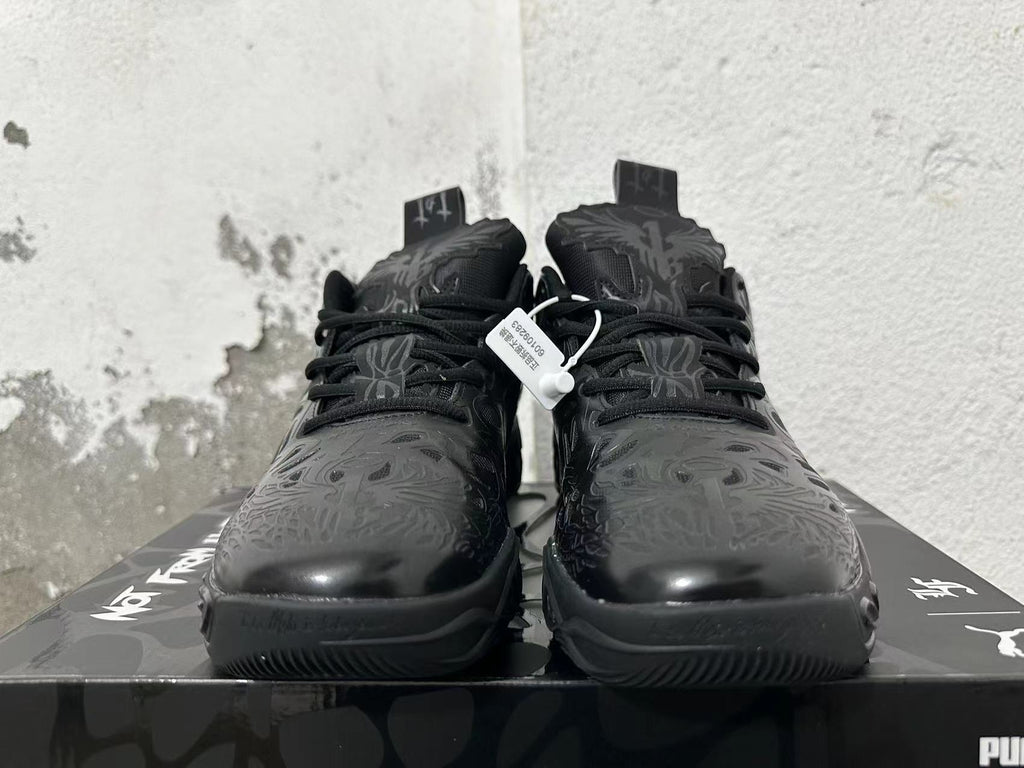 Front view of black lace-up basketball shoes with tonal patterned overlays.