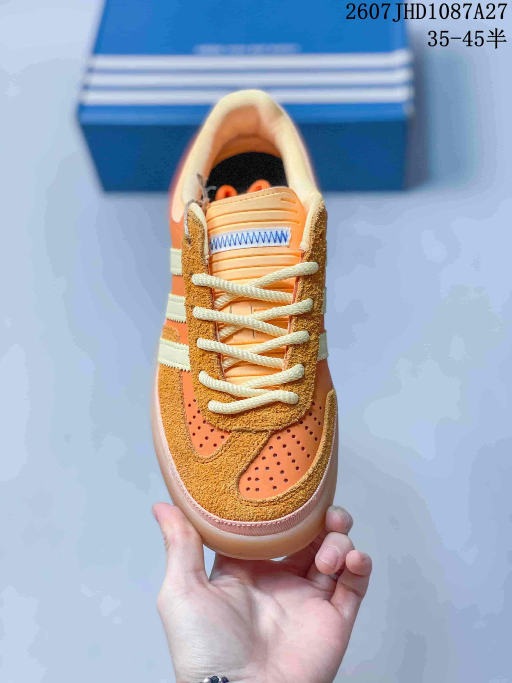 Top view showing the perforated toe, textured overlays and cream laces.