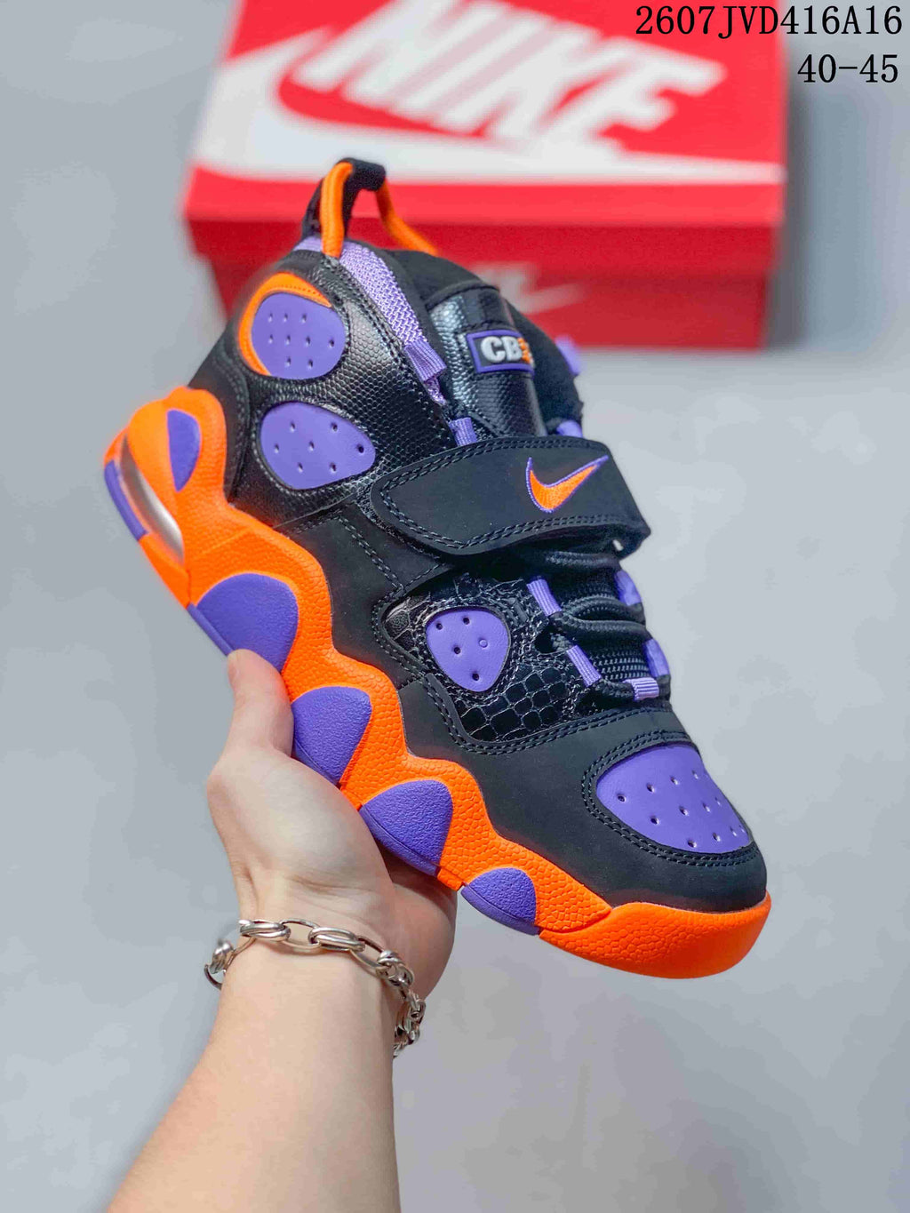 Black Nike high-top sneaker with purple and orange accents, perforated panels, laces and a hook-and-loop strap; style code 2607JVD416A16 and size range 40–45 are overlaid.