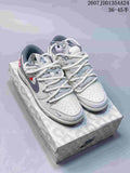 Pair of white and gray Nike Dunk Low Retro sneakers displayed on a patterned shoebox.