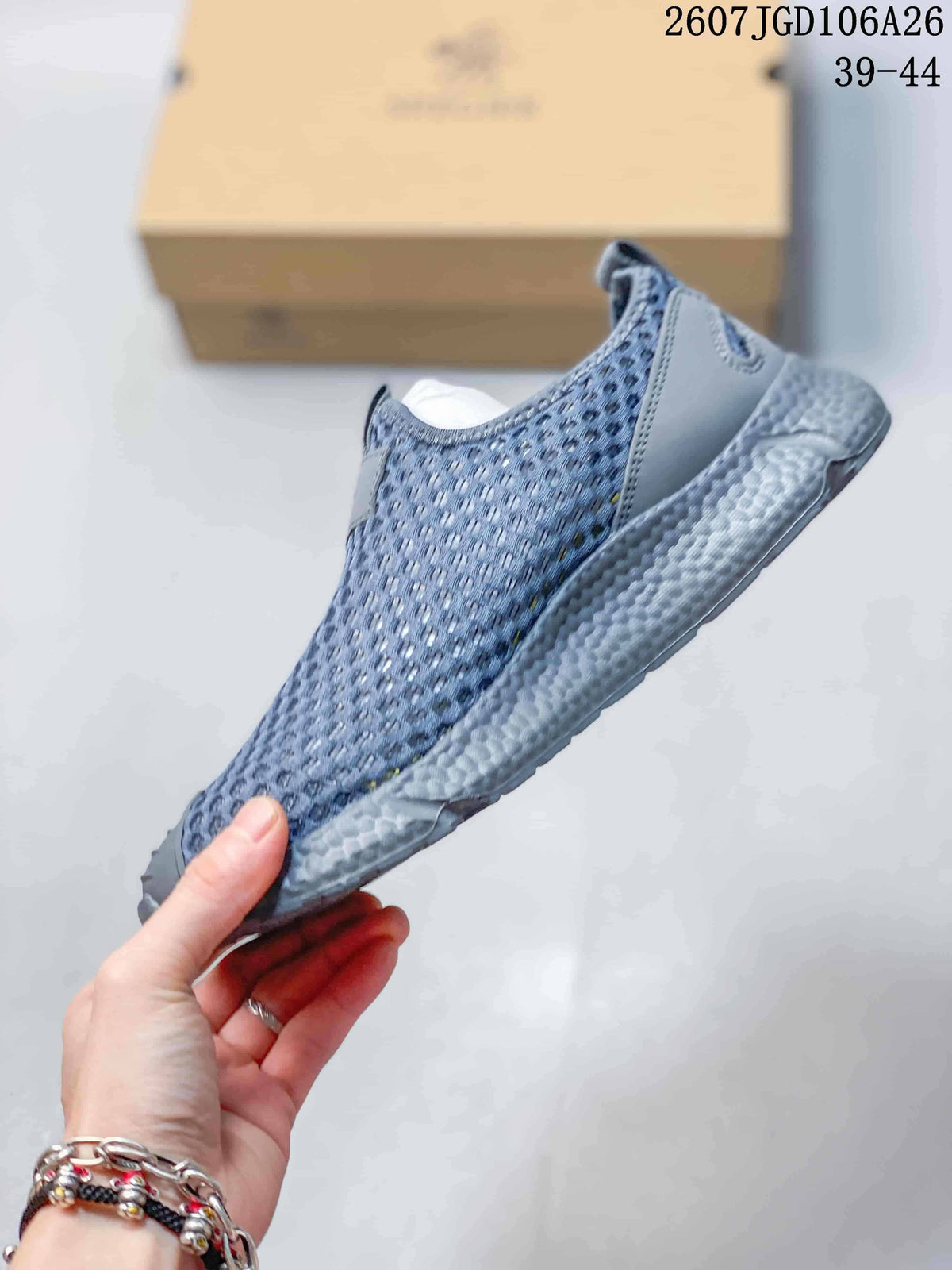 Side view of the sneaker showing the open mesh-style upper, toe overlay, and thick textured midsole.