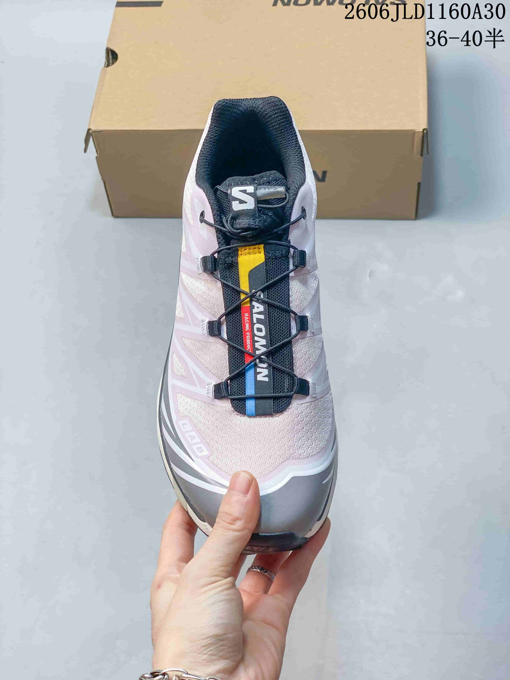 Front view showing the cord lacing and pale pink upper