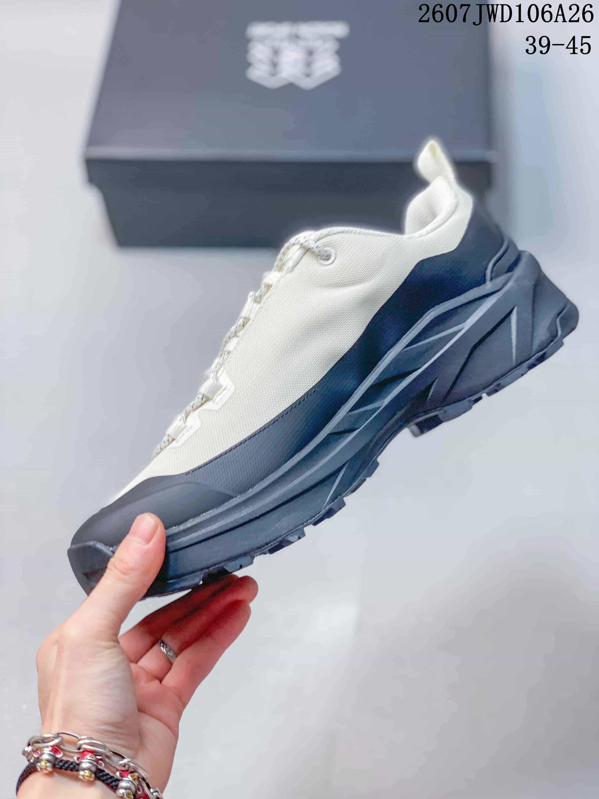 Side profile of the cream and black hiking shoe showing the layered sole, protective toe and heel pull tab, with source text showing 2607JWD106A26 and sizes 39–45.