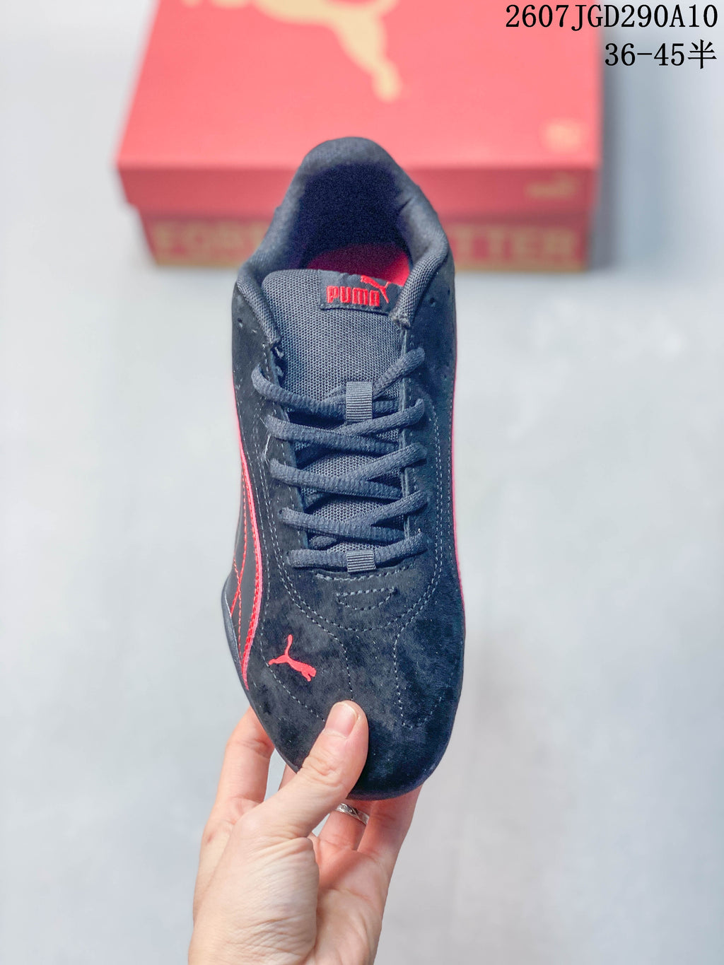 Top view of the black lace-up sneaker with red Puma branding on the tongue and toe.