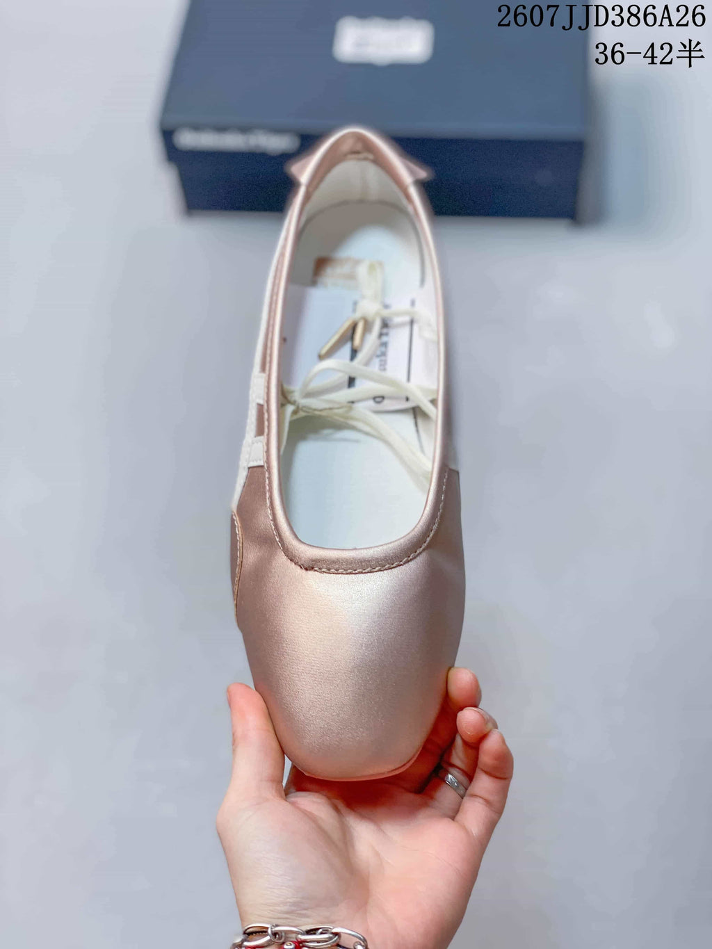 Top view of the pink shoe showing its rounded toe, open Mary Jane-style upper, and white laces or straps.