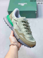 Angled side view of the Lacoste sneaker showing the crocodile logo, printed side branding, khaki overlays, and green heel accent.