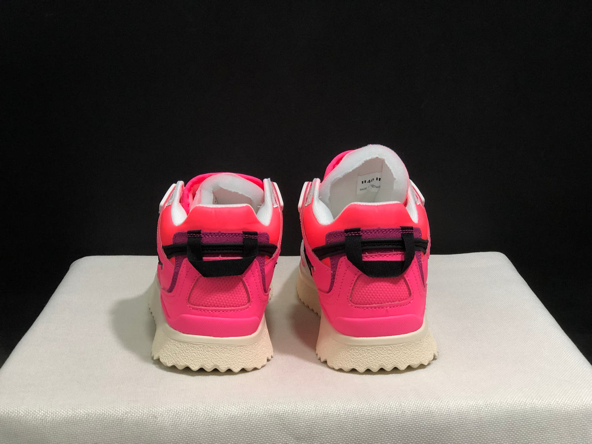 Rear view of the sneaker pair showing pink heel panels, black rear detailing, and cream outsoles.