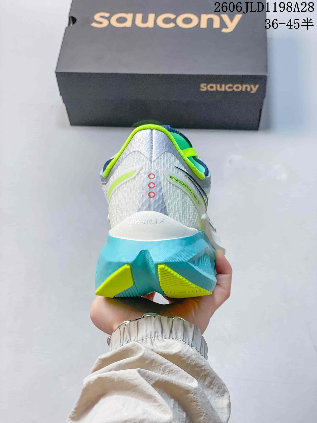 Rear view of the Saucony running shoe with aqua heel sole and yellow-green accents