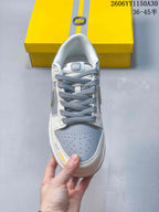 Top view of a Nike SB Dunk Low sneaker showing grey laces and perforated toe