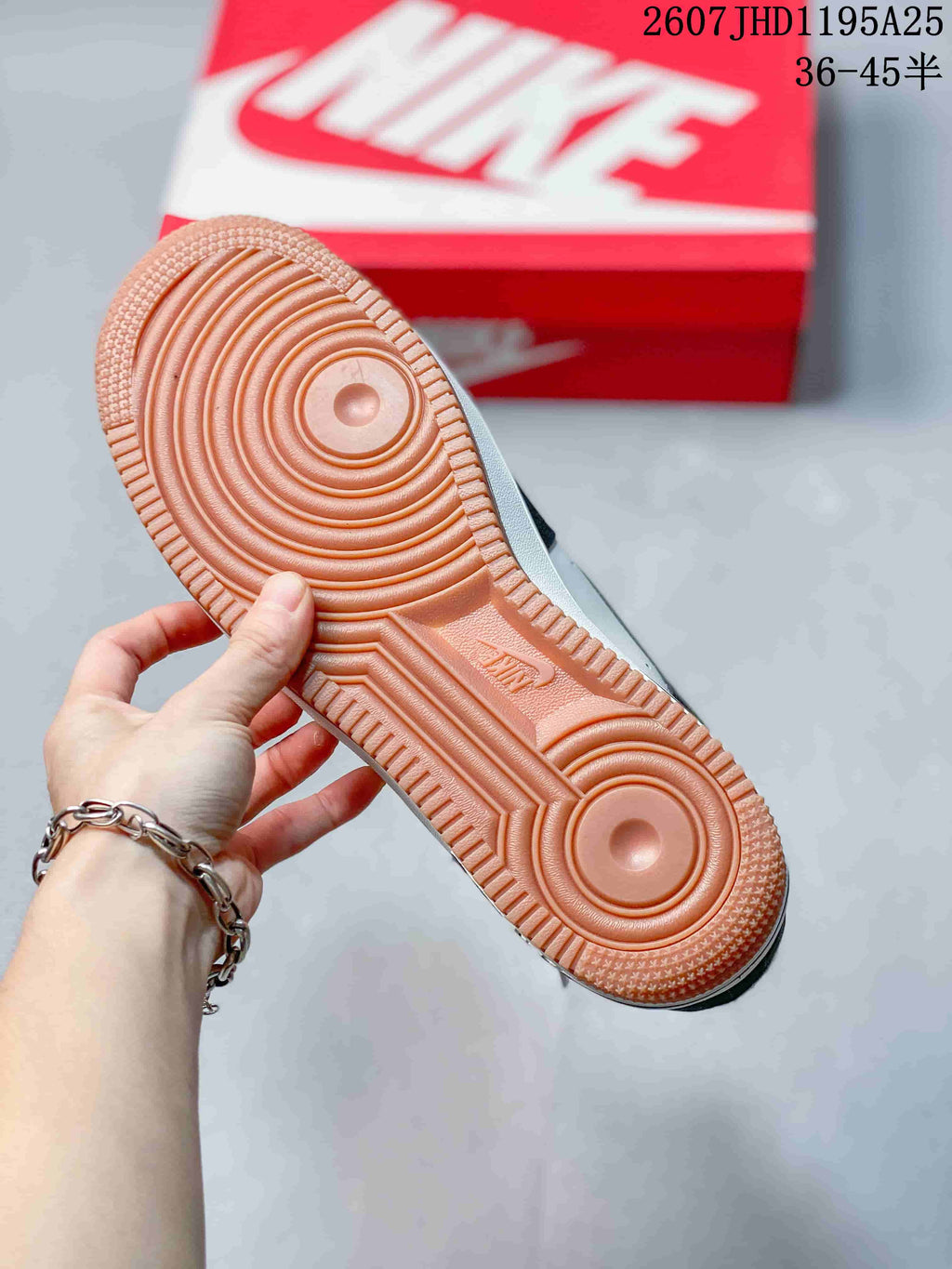 Close-up of the gum-colored outsole showing concentric traction patterns and a textured perimeter.