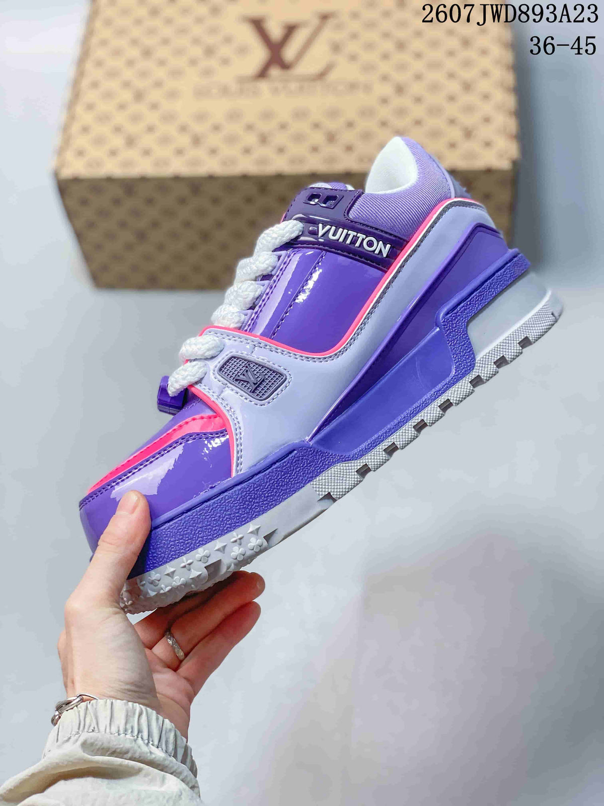 Side view of the sneaker highlighting the purple upper, grey overlays, pink trim, white laces, and chunky sole.