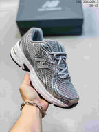 Angled side view of the grey and silver New Balance 740 sneaker with layered overlays and black outsole.
