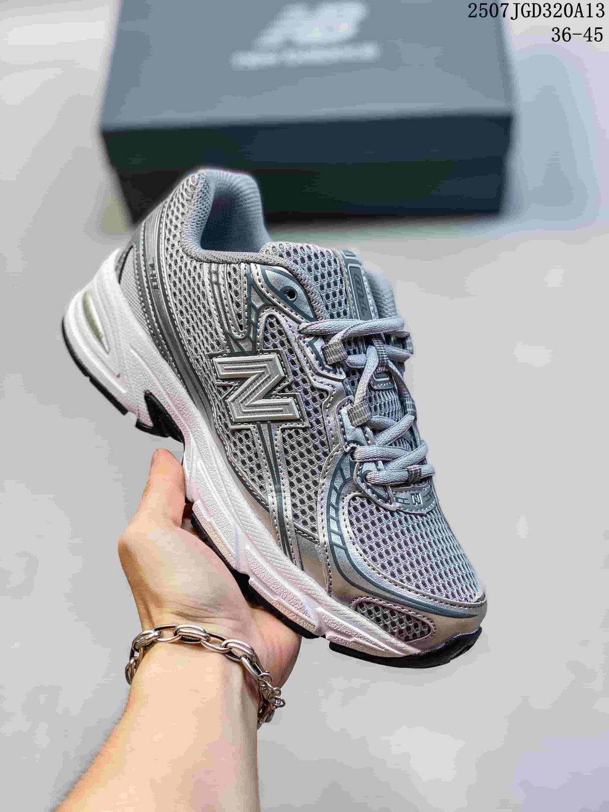 Angled side view of the grey and silver New Balance 740 sneaker with layered overlays and black outsole.