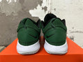 Rear view of green Nike shoes with black heel logos and white soles