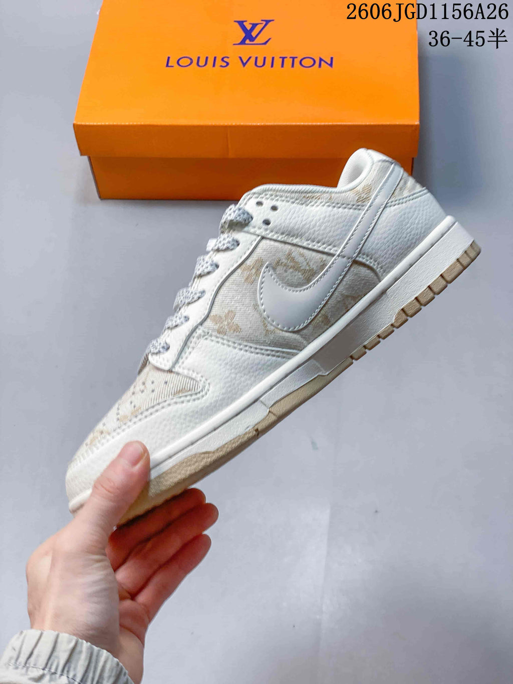 Side view of an ivory low-top sneaker with a white Swoosh and beige patterned panels.