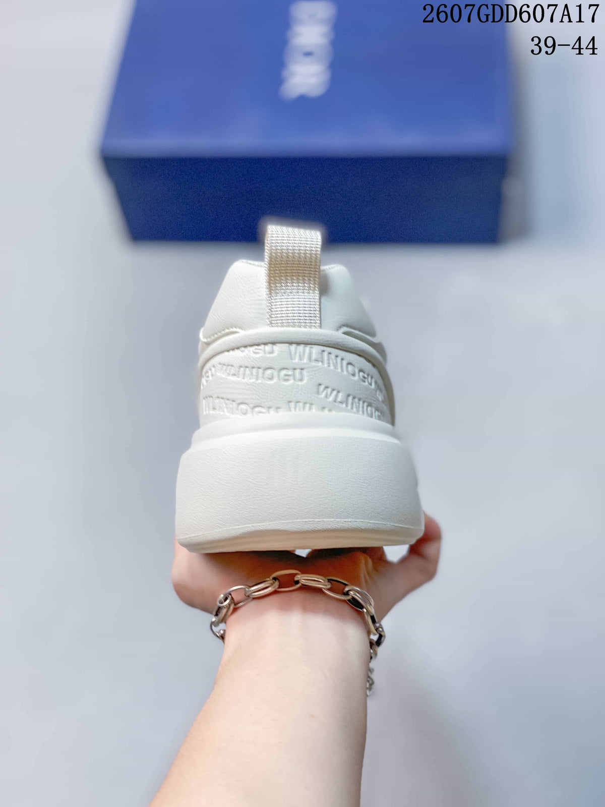 Rear view of the white sneaker showing the padded heel collar, pull tab and raised heel design.