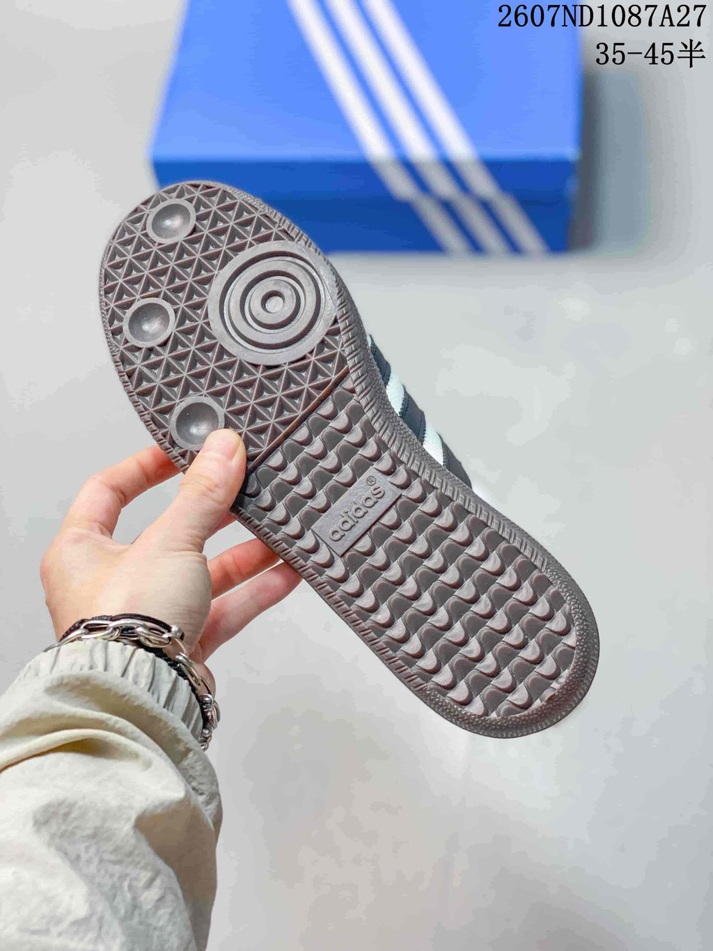 Underside view showing the brown textured outsole and circular traction details of the sneaker.