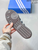 Underside view showing the brown textured outsole and circular traction details of the sneaker.