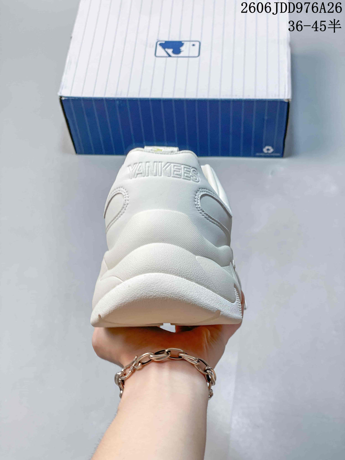 Rear view of the white sneaker showing raised heel lettering and the layered heel structure.