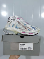 Balenciaga Runner 3120 sneaker in white with pink and blue accents displayed on its box; the box label shows size E 40.