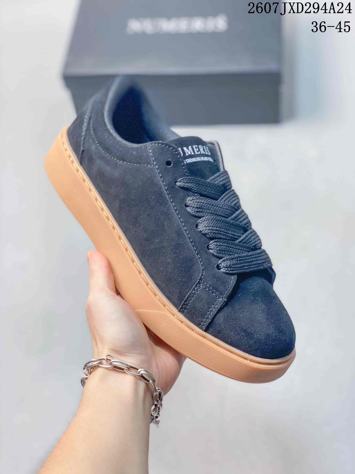Angled side view of a dark navy Numeris sneaker with tonal laces and a gum-colored platform sole.