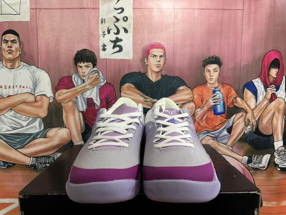 Front view showing white laces and purple toe accents on the basketball shoes.