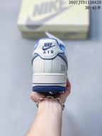 Rear view showing the white heel panel, blue outsole edge, and branded heel detailing.