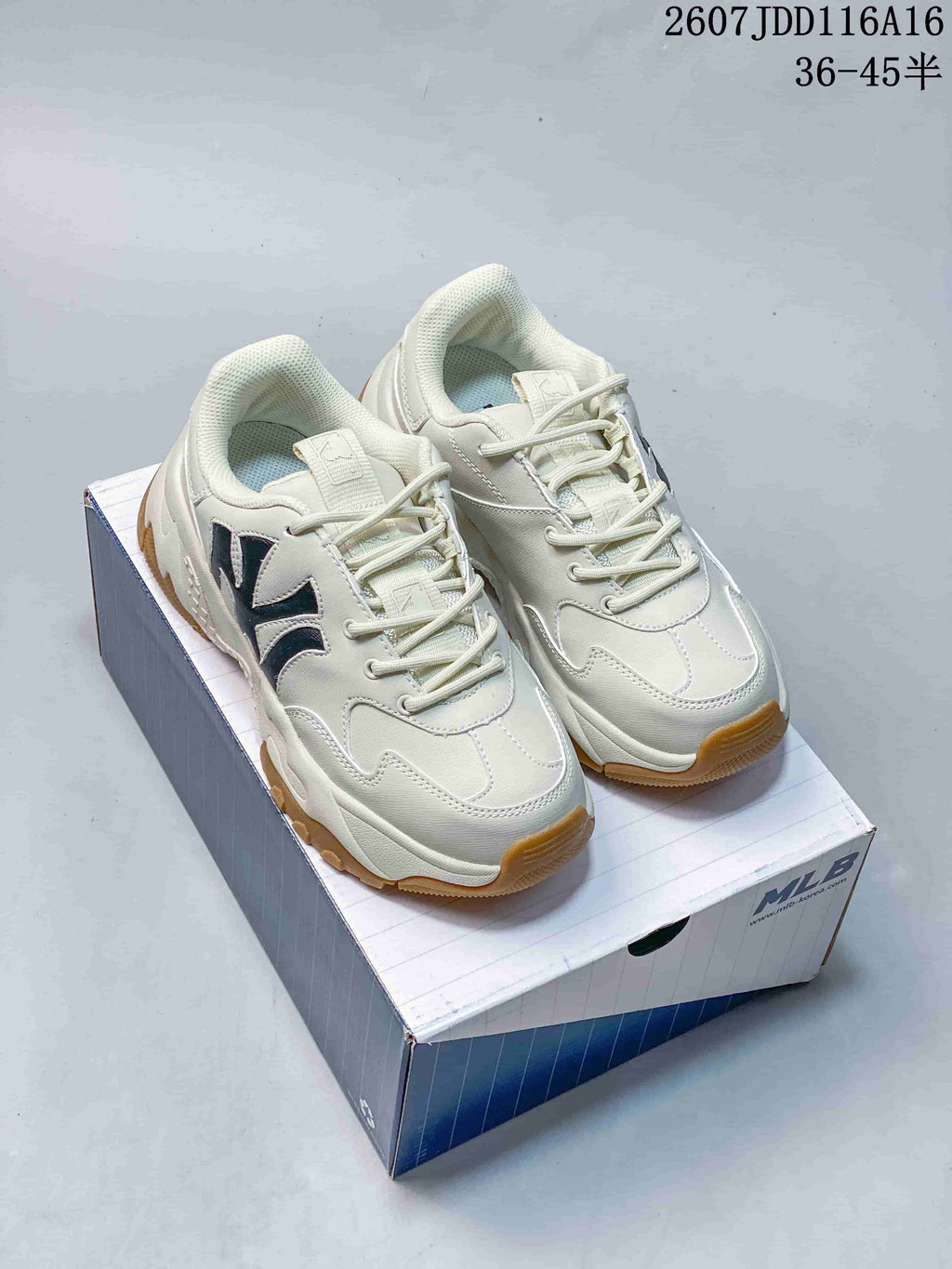 Pair of off-white MLB Bigball Chunky Window sneakers displayed on an MLB shoe box, showing dark side branding and gum-colored outsoles.