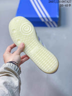 Close-up of the textured translucent rubber outsole with circular and patterned tread details.