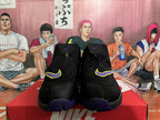 Front view of black Nike high-top basketball sneakers showing purple and neon yellow Swoosh accents and zippered closures.