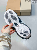 Underside of a Nike NOCTA Glide sneaker showing the white patterned outsole and dark traction sections.