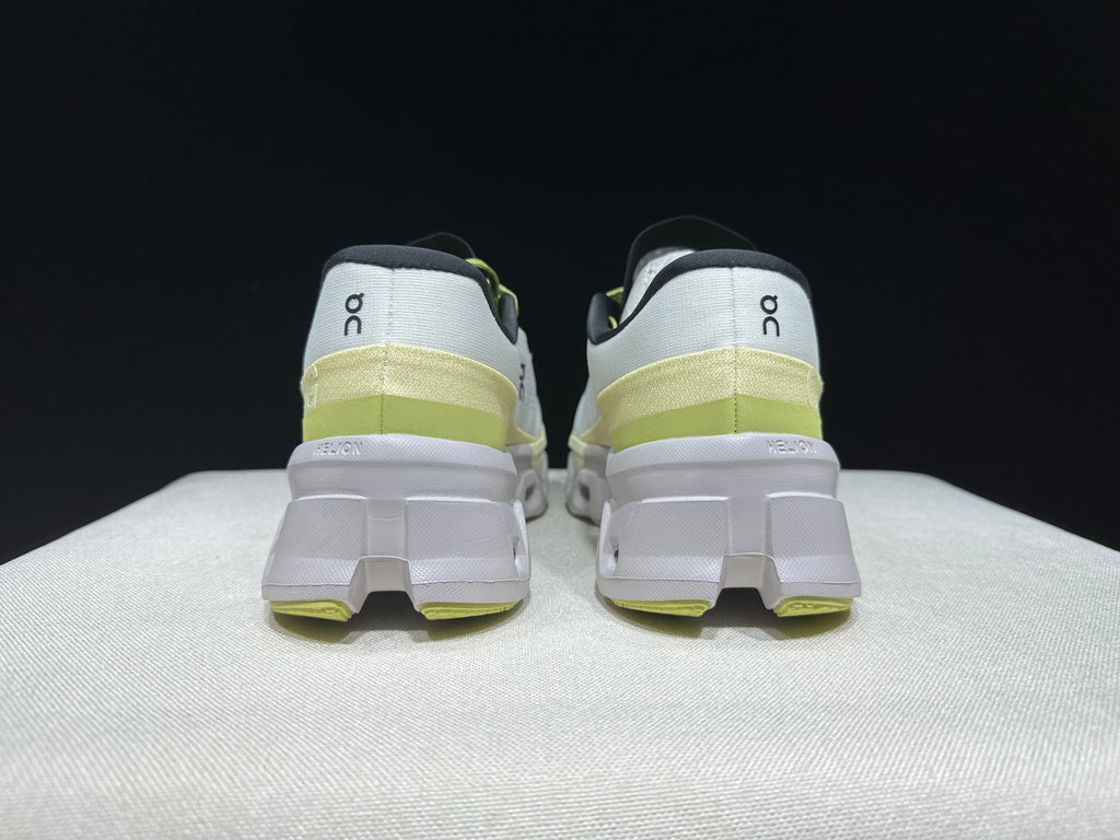 Rear view of the Cloudmonster 2 shoes showing the heel details and lime accents.