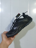 Black Balenciaga Radar sneaker shown from an angled side view, highlighting the mesh panels, layered overlays, laces, and rugged outsole.