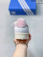 Rear view of the sneaker showing the pink Adidas heel patch and cream-colored sole.