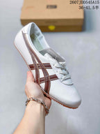 White low-top sneaker with brown side stripes, white laces, and a tan textured outsole.