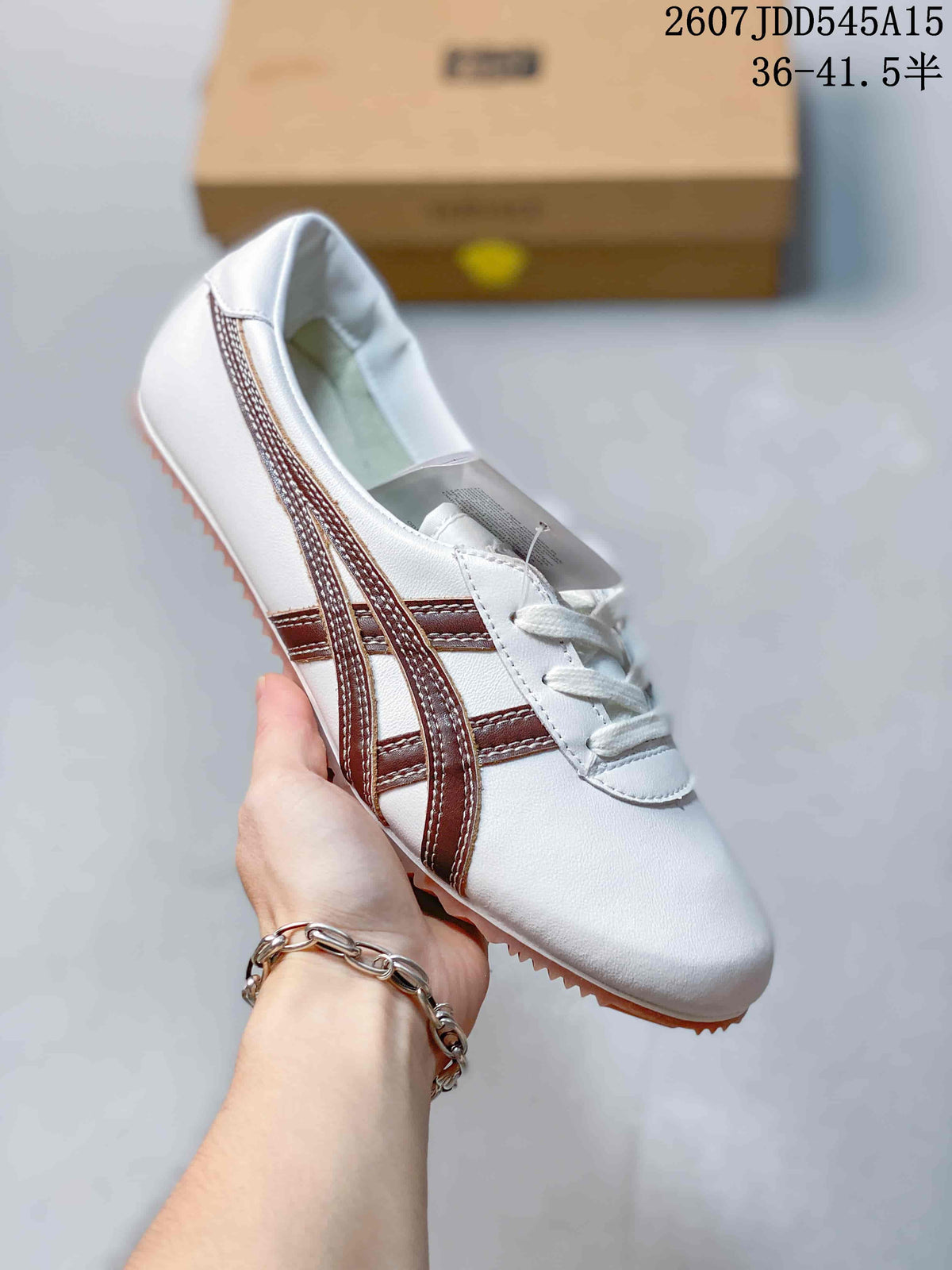 White low-top sneaker with brown side stripes, white laces, and a tan textured outsole.