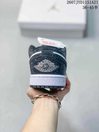 Rear view showing the black heel with a contrasting Air Jordan Wings motif, white midsole, and black outsole.